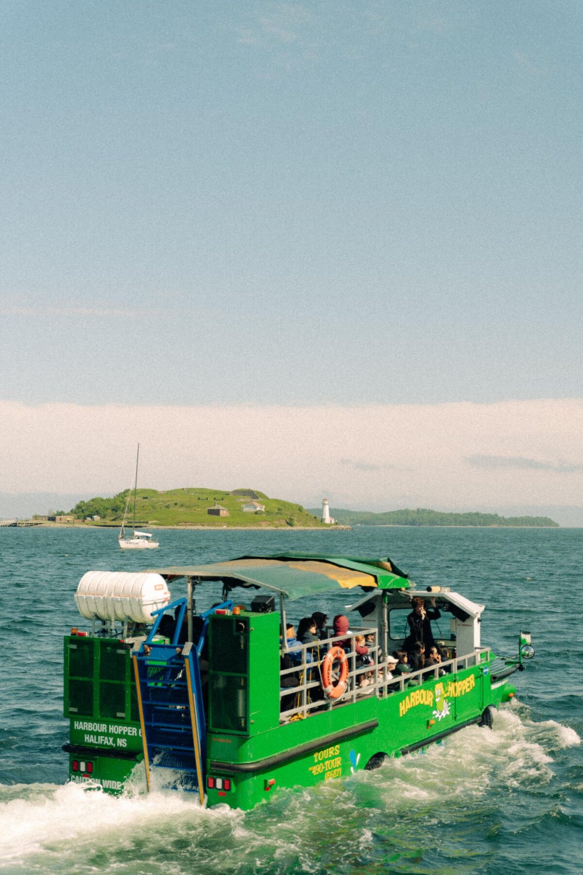 Harbour Hopper amphibious tour bus cruising through Halifax Harbour with Georges Island in the background.